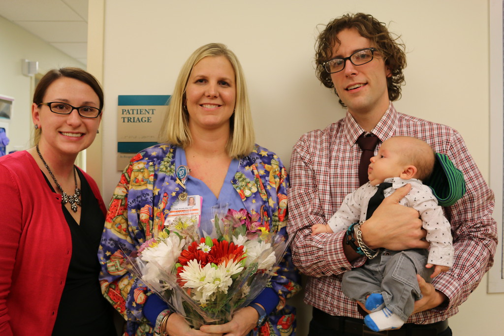 Tina Raab, RN, (center) receives a DAISY Award for excellence in nursing. Leah and Greg Meyer and their son Caleb attend the ceremony.