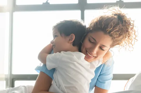 Nurse Hugging Kid