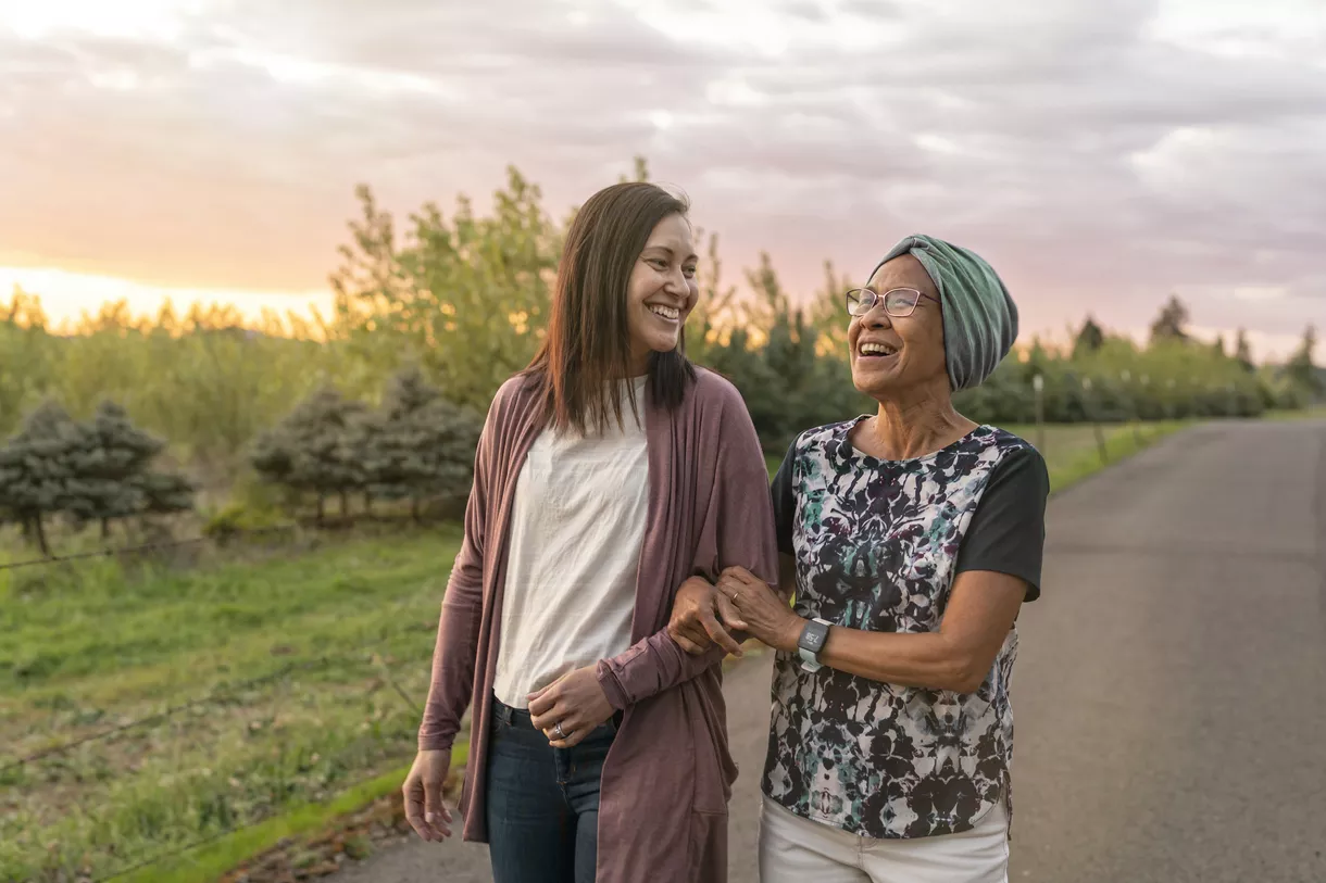 Cancer Care - Women walking outside at sunset