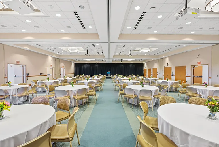 The full Doordan Institute banquet hall, set with round tables and a podium.