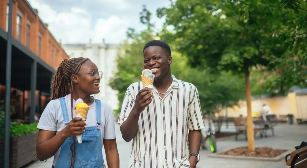 Two people walking and eating ice cream