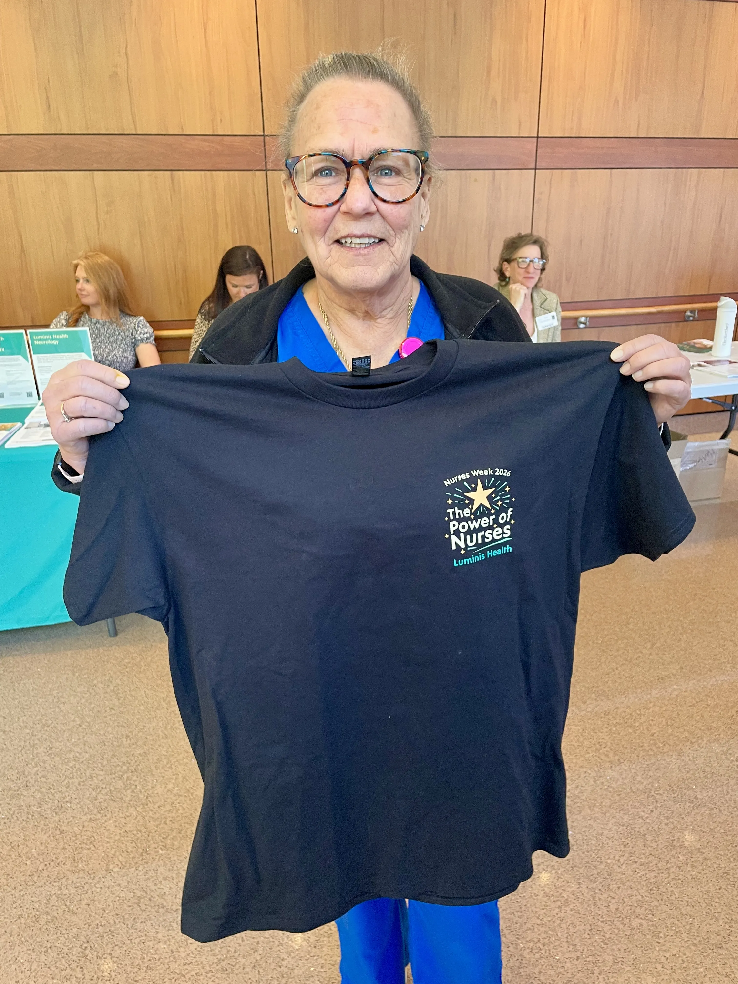 Nurse holding Nurses Week Shirt