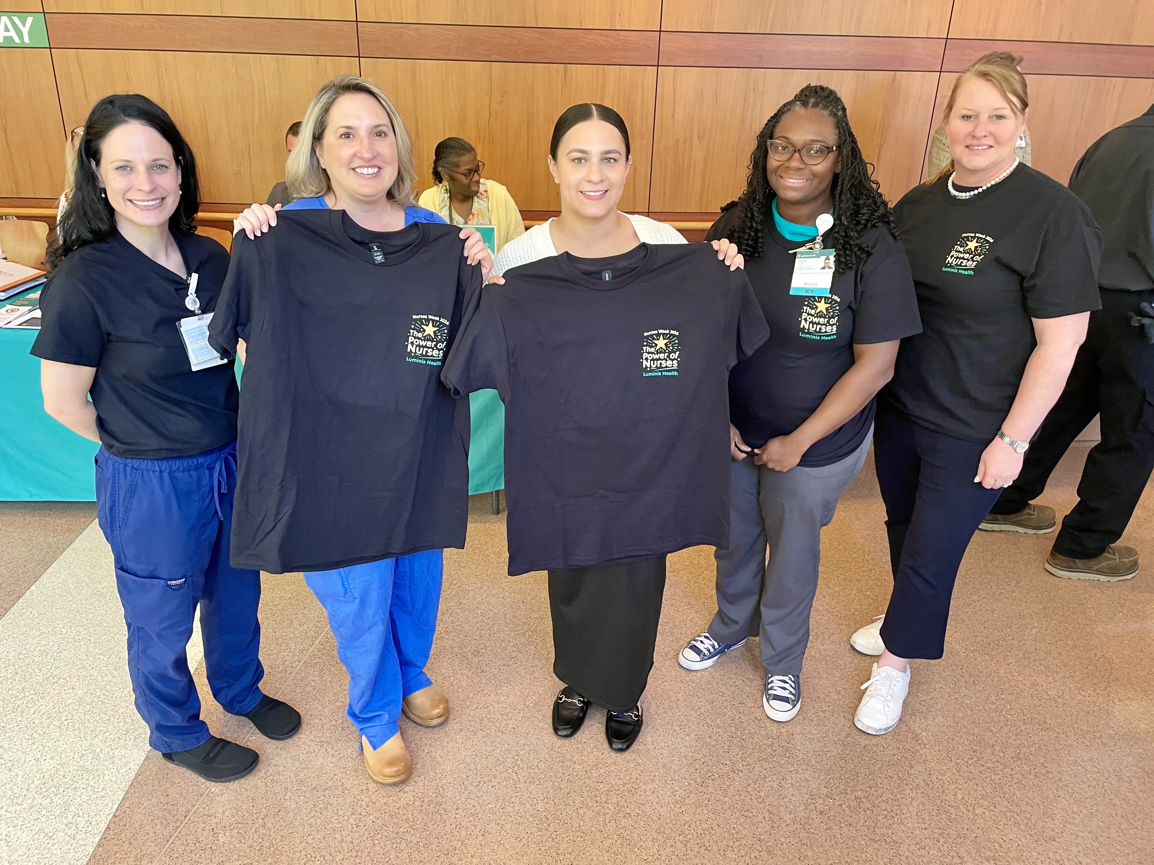 Nurses holding Nurses Week Shirts