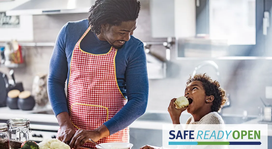 Parent cooking with daughter
