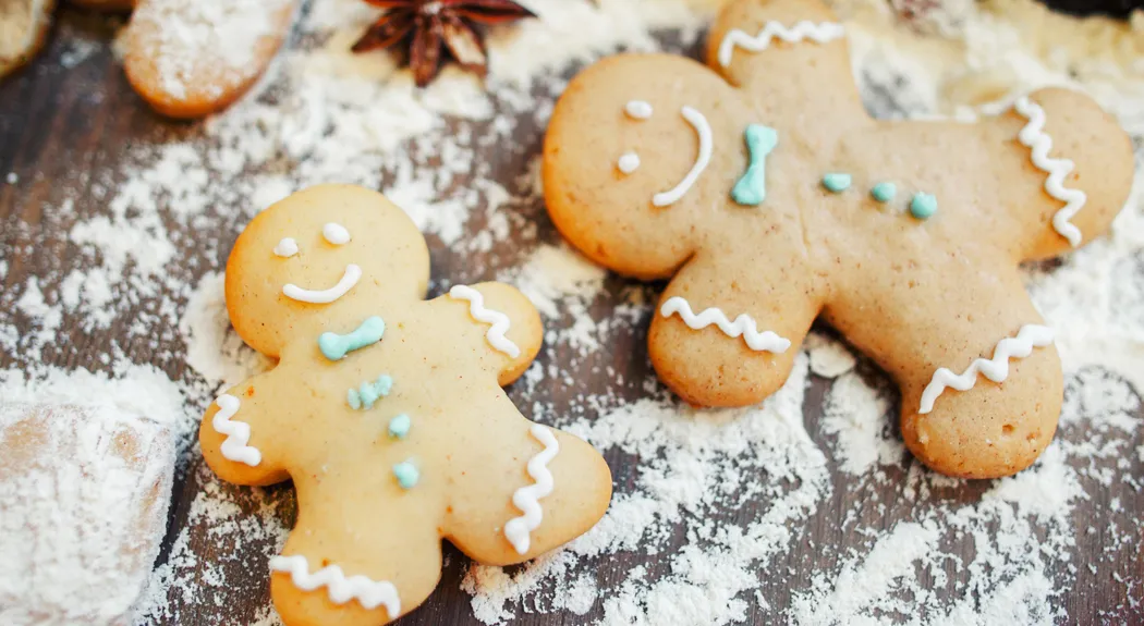 Gingerbread men on floured table, close-up