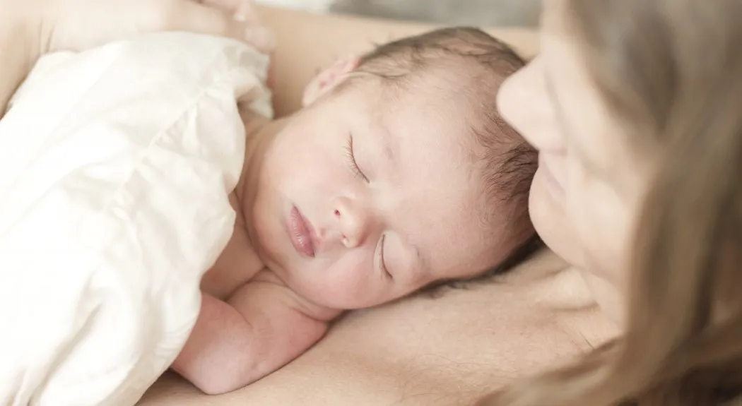 newborn baby laying on mom_Blogcrop